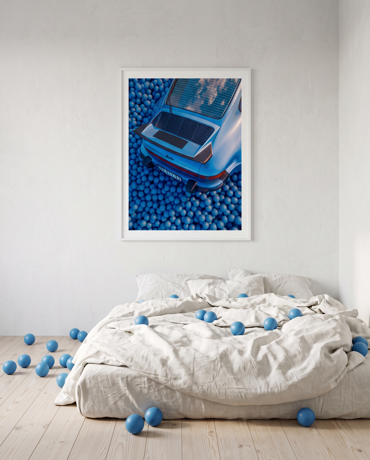 AZUR 03 framed above a bed with white linen, blue balls on the duvet and the floor