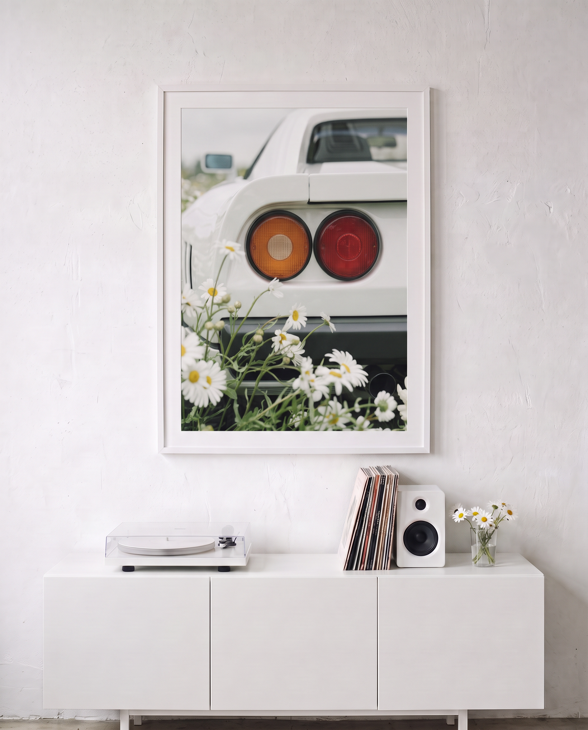 WHITE 04 framed above a white sideboard with a record player and vinyl records