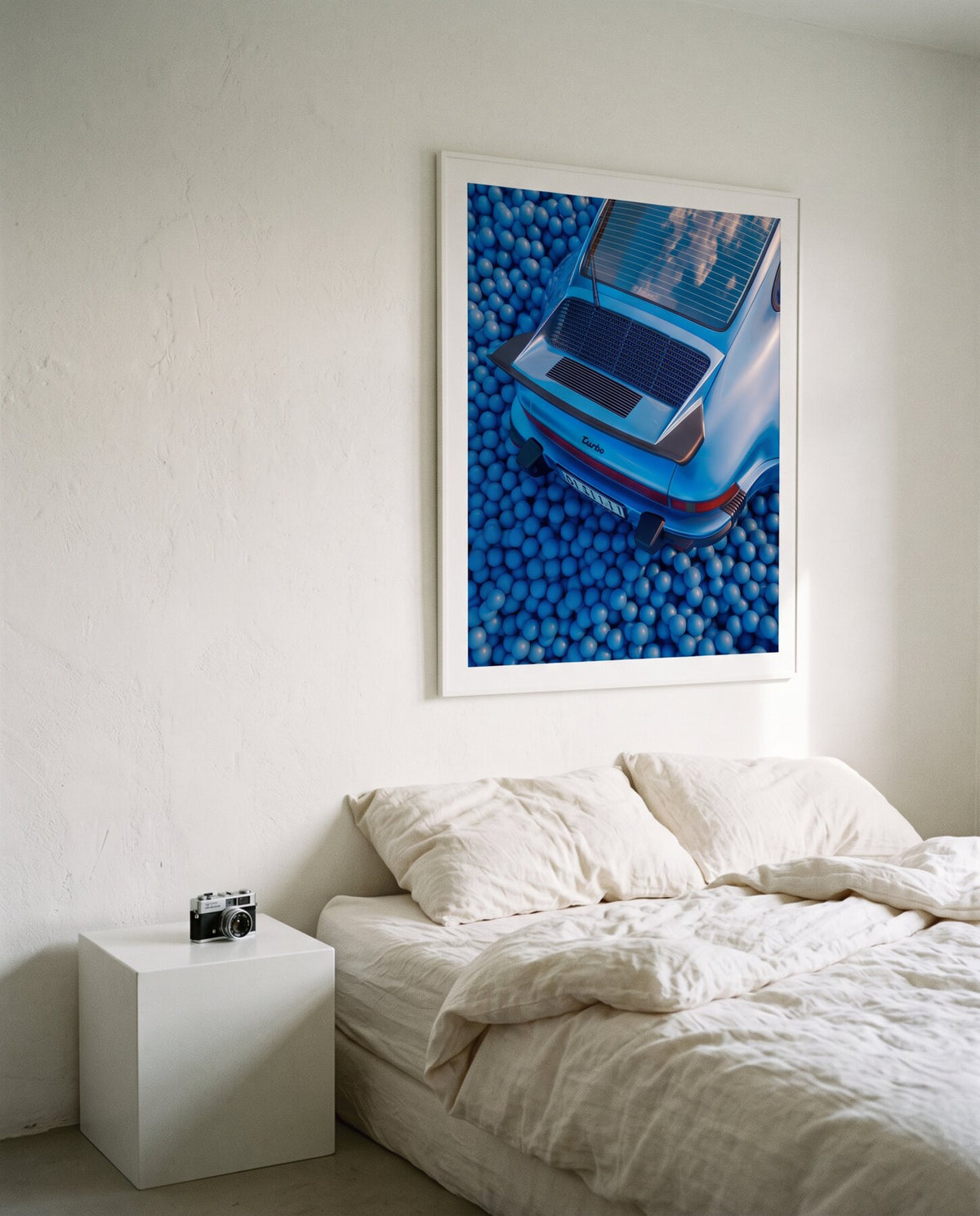 AZUR 03 framed above a bed with white linen