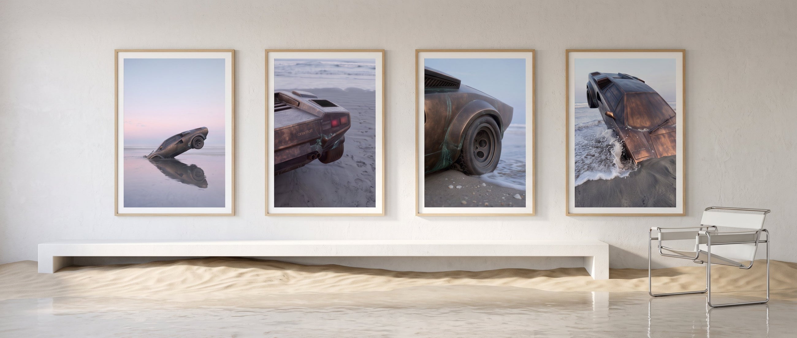 The four ODYSSEY prints framed in a white room where sand has drifted across the floor
